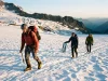 Is Mt Rainier Hard in Summer? Fitness Decides Roped climbing team crossing the Ingraham Glacier on Mt Rainier at sunrise in summer