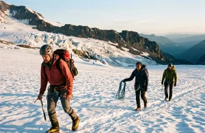 Is Mt Rainier Hard in Summer? Fitness Decides Roped climbing team crossing the Ingraham Glacier on Mt Rainier at sunrise in summer