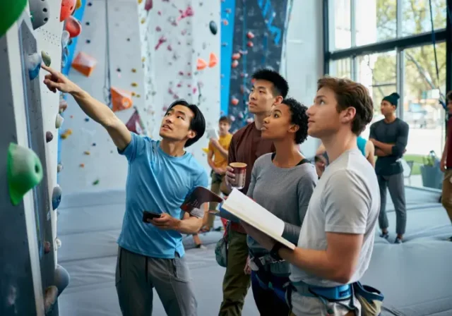Choosing a Berkeley rock climbing gym: diverse climbers thoughtfully reviewing options in a modern gym, an expert review.