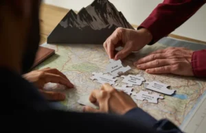 Climbing Mt Everest: The REAL Prerequisites You Need The REAL prerequisites for climbing Mount Everest: hands assembling puzzle pieces of experience, skill, fitness, and logistics with Everest in background.