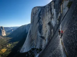 Panoramic view of El Capitan with the Freerider route subtly highlighted and two tiny climbers, illustrating a comprehensive route plan.
