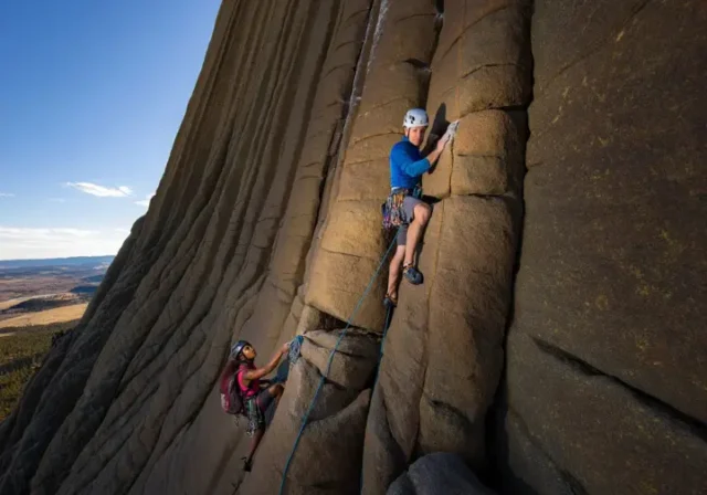 Mastering climbing Devils Tower, Wyoming: diverse climbers on a classic route, showcasing routes, regulations, and respect.