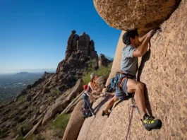 Mastering climbing the Praying Monk on Camelback Mountain: diverse climbers on a classic route with Phoenix in the background.