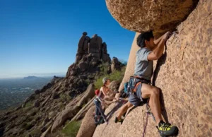 Master Climbing the Praying Monk (Camelback Mountain) Mastering climbing the Praying Monk on Camelback Mountain: diverse climbers on a classic route with Phoenix in the background.