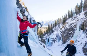 Master Lake City Ice Climbing: Park, Routes & Secrets Mastering Lake City ice climbing: diverse climbers on a tall blue ice formation in the park, showcasing routes and the promise of secrets.