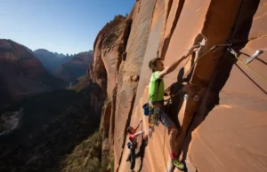 Master Zion Rock Climbing: Big Walls, Routes & Permits Mastering rock climbing in Zion: climbers on a big wall, showcasing routes, permits, and respect for Zion National Park.