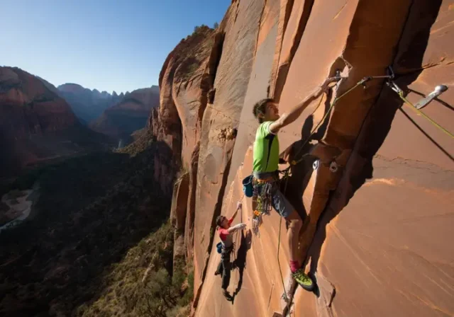 Mastering rock climbing in Zion: climbers on a big wall, showcasing routes, permits, and respect for Zion National Park.
