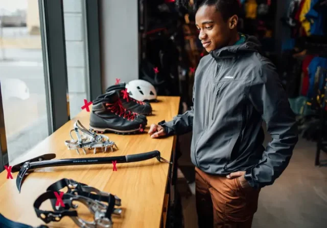 Person considering essential mountain climbing gear, highlighting the need to choose correctly and avoid mistakes.