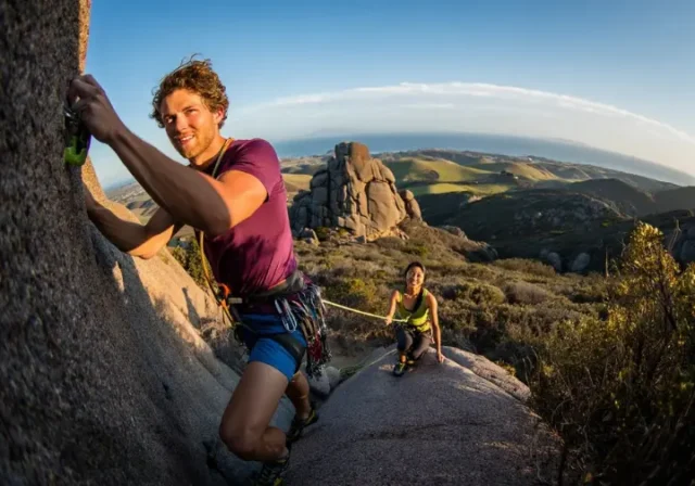 Ultimate 2025 guide to rock climbing in San Luis Obispo: diverse climbers on a volcanic rock face at Bishop Peak with coastal views.