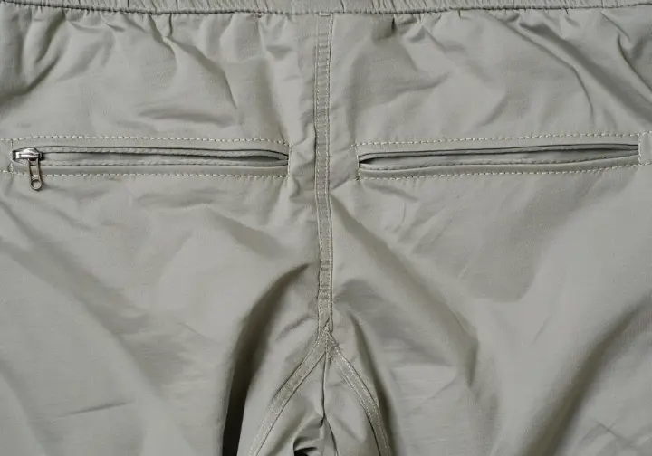Explaining key features: Close-up showing gusseted crotch, articulated knees, and harness-compatible waistband on women's climbing pants.