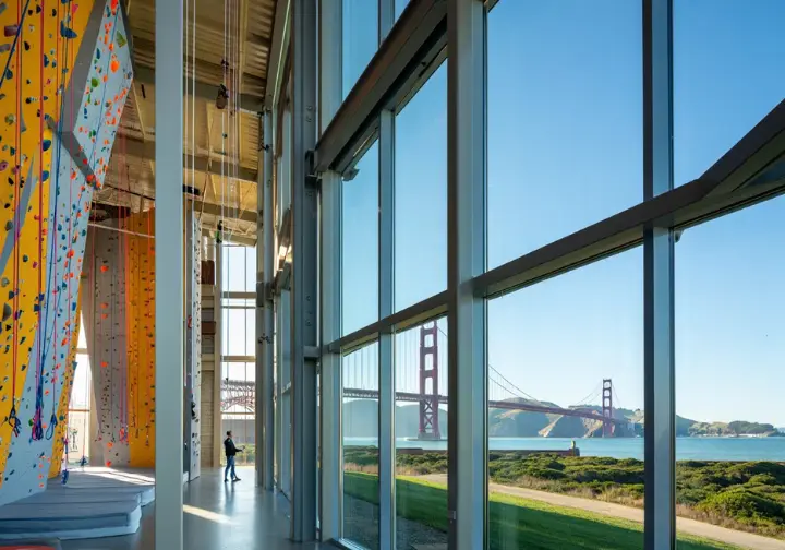 Movement Presidio deep dive: Interior view of the climbing gym with stunning Presidio National Park scenery visible through windows.