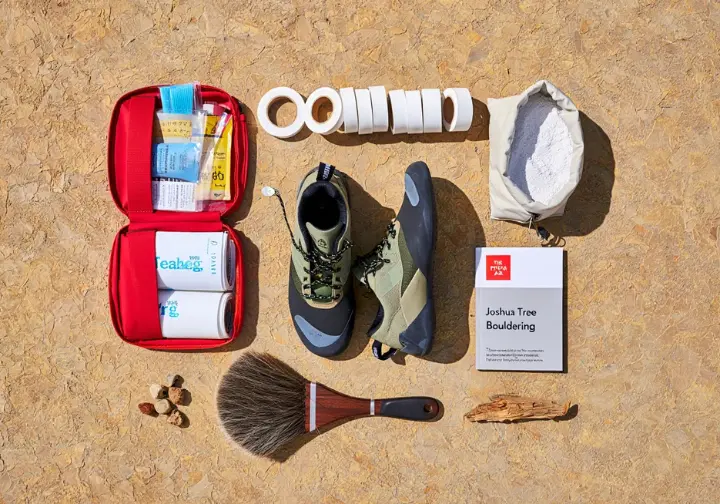 Essential bouldering kit for Joshua Tree, including climbing shoes, chalk bag, and guidebook, as part of a joshua tree bouldering guide.