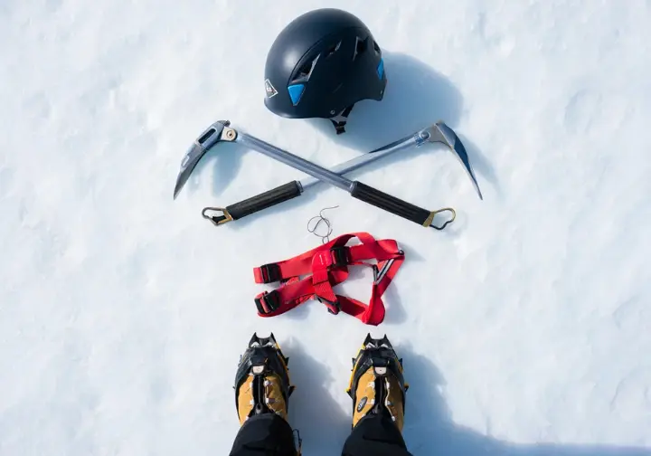 Essential climbing information: Flat lay of mandatory ice climbing gear (boots, crampons, tools, helmet, harness) for Ouray Ice Park.