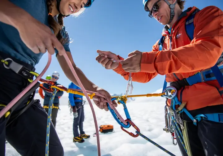 Mastering essential technical mountaineering skills: diverse climbers practicing crevasse rescue, a prerequisite for climbing Mount Everest.