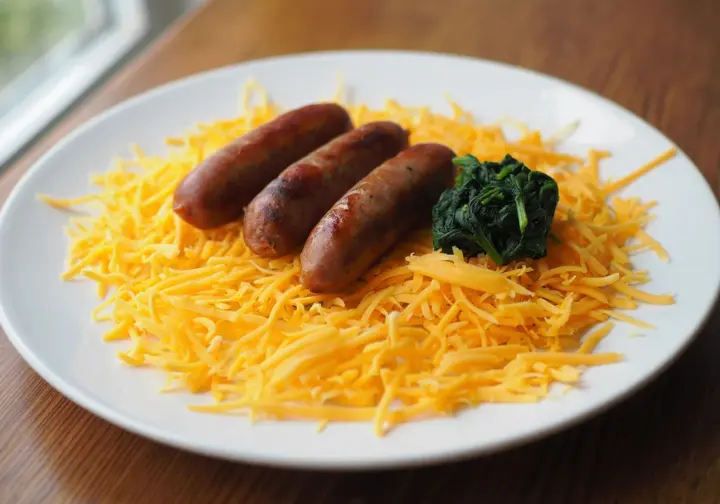 Risks and side effects of HFLC diets: A plate showing potential nutrient deficiency risks with mostly processed meat/cheese and few vegetables.