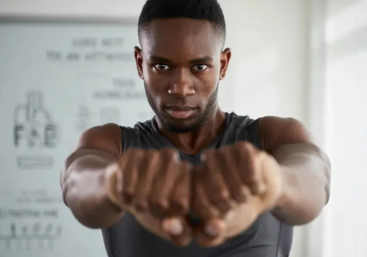 Athlete performing a precise Functional Range Conditioning (FRC) shoulder CAR, an advanced concept in a mobility routine for athletes.
