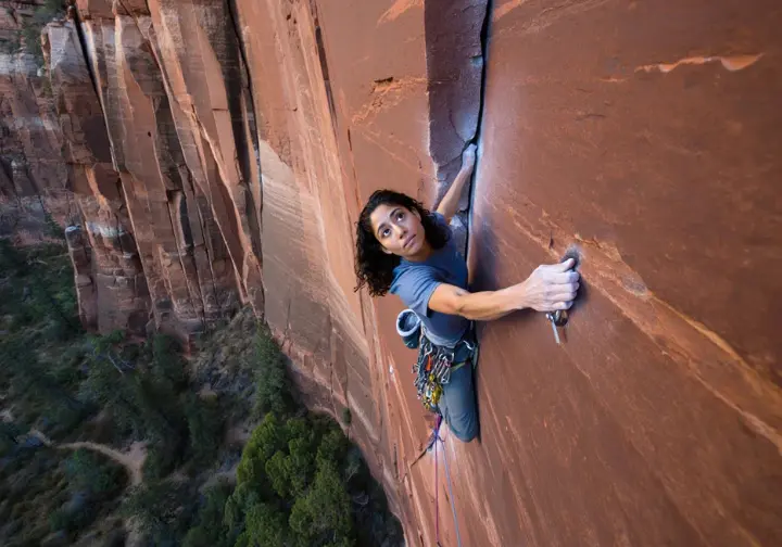 Conquering giants in Zion: climber on an iconic big wall route, showcasing information and beta for climbing in the National Park.