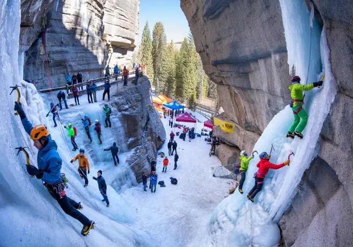 Ouray Ice Festival guide: Busy scene showing climbers, spectators, and vendor tents during the annual event at the park.
