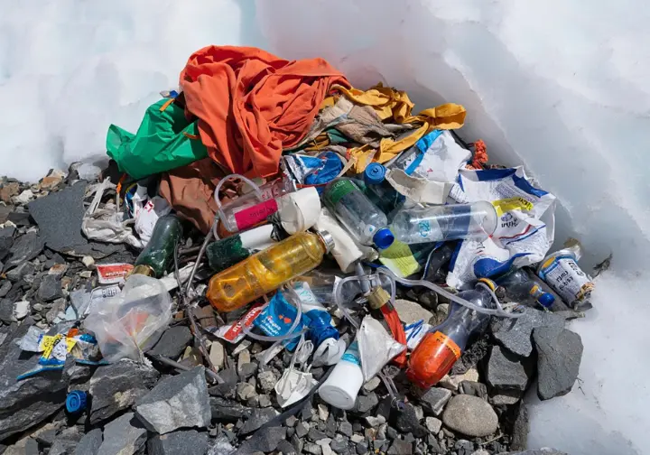 Environmental impact high up: Accumulated waste including oxygen bottles and tent remnants visible at Everest Camp 4.