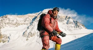 Everest Prerequisites — the Permit Is the Easy Part Climber in La Sportiva double boots on a fixed line high on Everest, the prerequisites for climbing Mount Everest behind