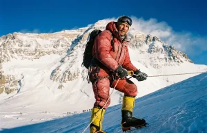 Everest Prerequisites — the Permit Is the Easy Part Climber in La Sportiva double boots on a fixed line high on Everest, the prerequisites for climbing Mount Everest behind
