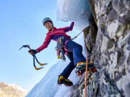 Skilled mixed climber transitioning from ice to rock, using ice tools and crampons on both surfaces, illustrating a guide to mastering mixed climbing essentials.