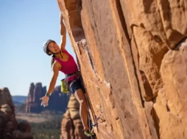 Climber on a striking sport route, with glimpses of diverse North American crags (sandstone, limestone, granite) in the background, representing top sport climbing destinations you can't miss.