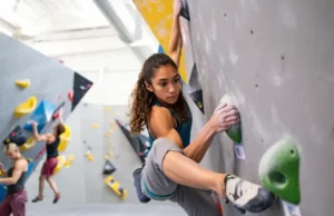 Unlock Intermediate: Progress Indoor Climb Skills Climber making a skillful move on an intermediate indoor climbing route, progressing from beginner to intermediate indoor climbing skills with improved technique and confidence.