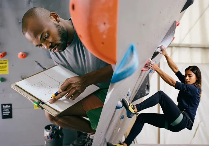 Scene depicting the lifecycle of a gym climb: from a route setter's design sketch (concept) to bolting holds, to a climber attempting the crux.