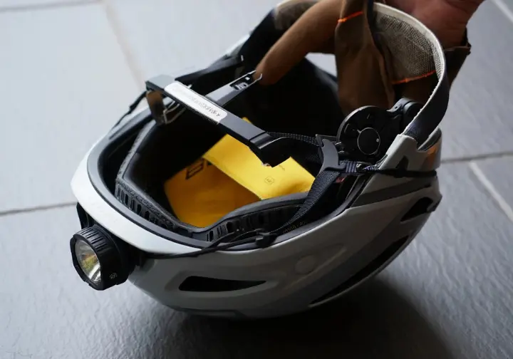 Close-up of a climbing helmet showcasing essential features like ventilation, headlamp clips, and adjustment system, considerations beyond fit.