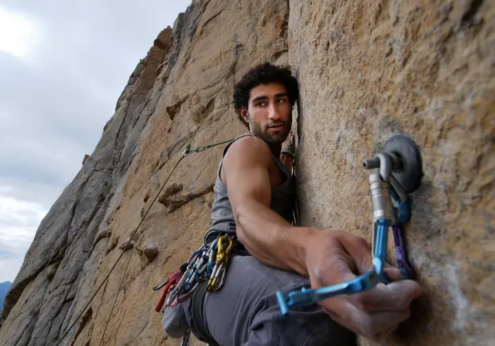 A climber making the sensible decision to retreat from a difficult route, showcasing good judgment to avoid exceeding abilities and prevent human error.
