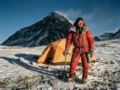Camp 4 on Everest Isn’t for Resting, It’s for Waiting Climber in a red down suit on Everest's Camp 4 on the South Col at dusk