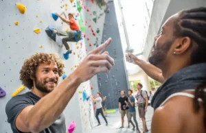 Beyond The Record: Climbing The World’s Top Walls Diverse climbers ascend a massive, modern artificial climbing wall, symbolizing the challenge and scale of the largest climbing walls in the world.