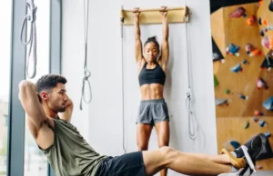 Core & Grip: A Climber’s Gym Workout Plan Diverse climbers performing core and grip exercises in a modern gym, illustrating a comprehensive gym workout plan for climbers.