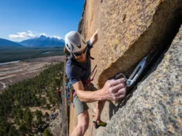 A climber on a rock face, demonstrating the ethics and craft of a modern first ascent in a natural outdoor setting.