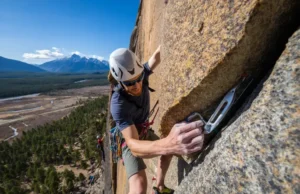 The Ethics & Craft of the Modern First Ascent A climber on a rock face, demonstrating the ethics and craft of a modern first ascent in a natural outdoor setting.