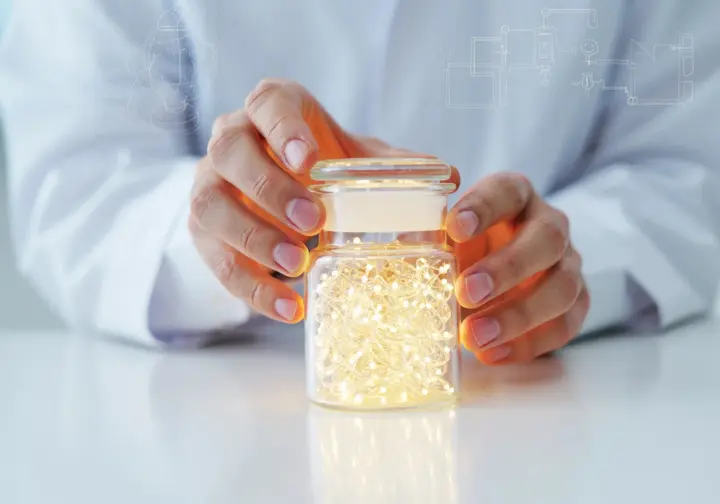 A clear glass jar containing glowing ketone bodies on a lab bench, with subtle scientific diagrams in the background, representing the metabolic science of ketosis for a ketogenic diet.