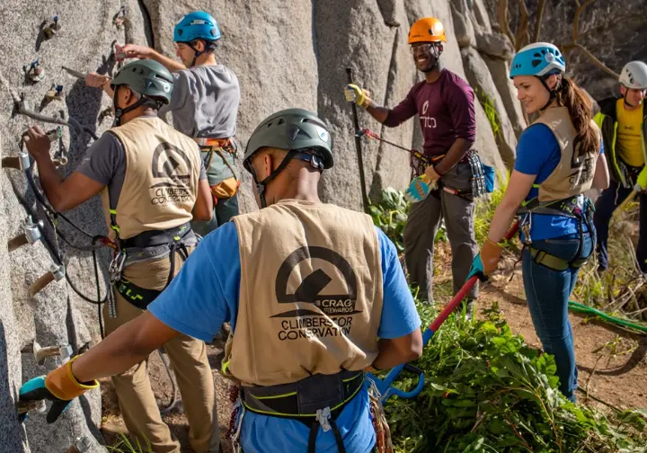Climbers representing organizations working on crag stewardship, illustrating the role of guardians in modern first ascent route development.