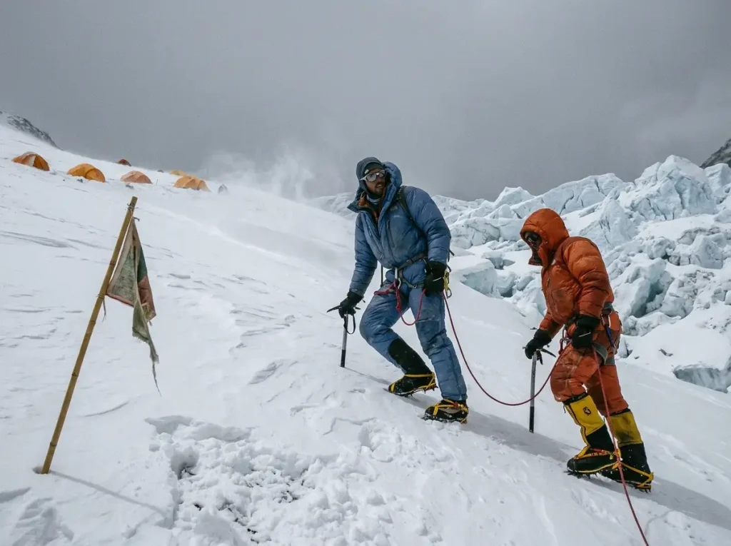 Roped climbers descending from Camp 1 toward Base Camp during an acclimatization rotation