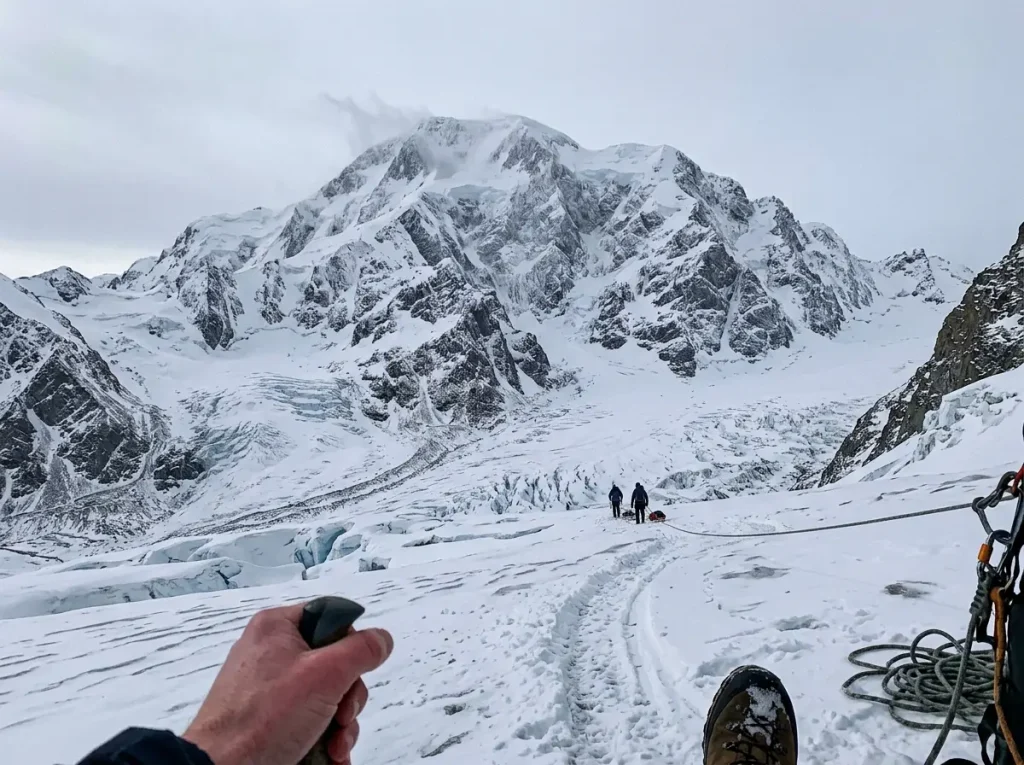 Denali, North America's highest peak, rising snow-plastered above the Alaska Range under grey sky