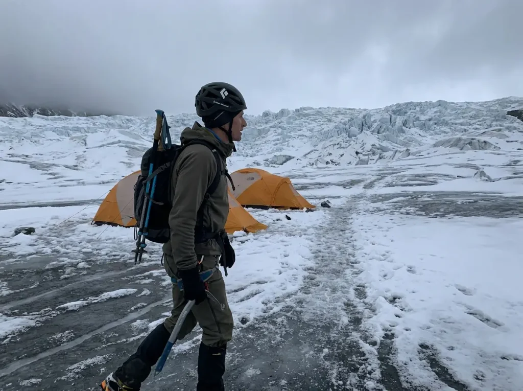 Fast-and-light climber moving quickly past Camp 1 tents toward Camp 2 on Everest