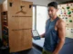 Climbing Assessment: A Data-Backed Framework to Find & Fix A dedicated climber analyzes performance data on a tablet in their home training area, demonstrating a data-backed framework to assess and fix climbing weaknesses.