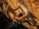 The Science of the Pump: A Climber’s Complete Training Blueprint A determined climber fights through forearm pump high on a steep rock face, illustrating the central theme of the science of climbing endurance and training.