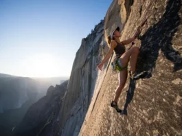 A climber demonstrates masterful footwork on a massive granite wall, embodying the science and art of an edging and smearing masterclass.