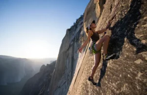 The Science of Footwork: An Edging & Smearing Masterclass A climber demonstrates masterful footwork on a massive granite wall, embodying the science and art of an edging and smearing masterclass.