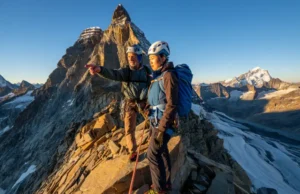 Matterhorn Guides Compared: 2025 Guide to a Safe Climb A certified mountain guide leads a climber safely along a narrow, exposed rock ridge during a guided ascent of the Matterhorn.