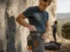 How to Choose Quickdraws for Your First Real Rack Climber racking Petzl Spirit Express quickdraws on a harness before a sport route
