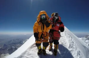 Mt Everest Expeditions 2025: Cost, Routes & Success Odds Full-body shot of two climbers in full mountaineering gear roped together, crossing a narrow snow ridge high in the Himalayas.