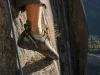 Why Stickier Climbing Shoe Rubber Isn’t Better Climber's foot in a La Sportiva TC Pro edging on a small granite crimp in low evening light