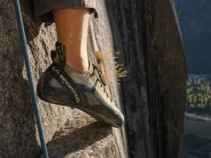 Why Stickier Climbing Shoe Rubber Isn’t Better Climber's foot in a La Sportiva TC Pro edging on a small granite crimp in low evening light